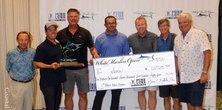 group of men holding big check for winning first place in the blue marlin category
