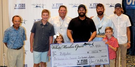 group of men holding check for third place white marlin open